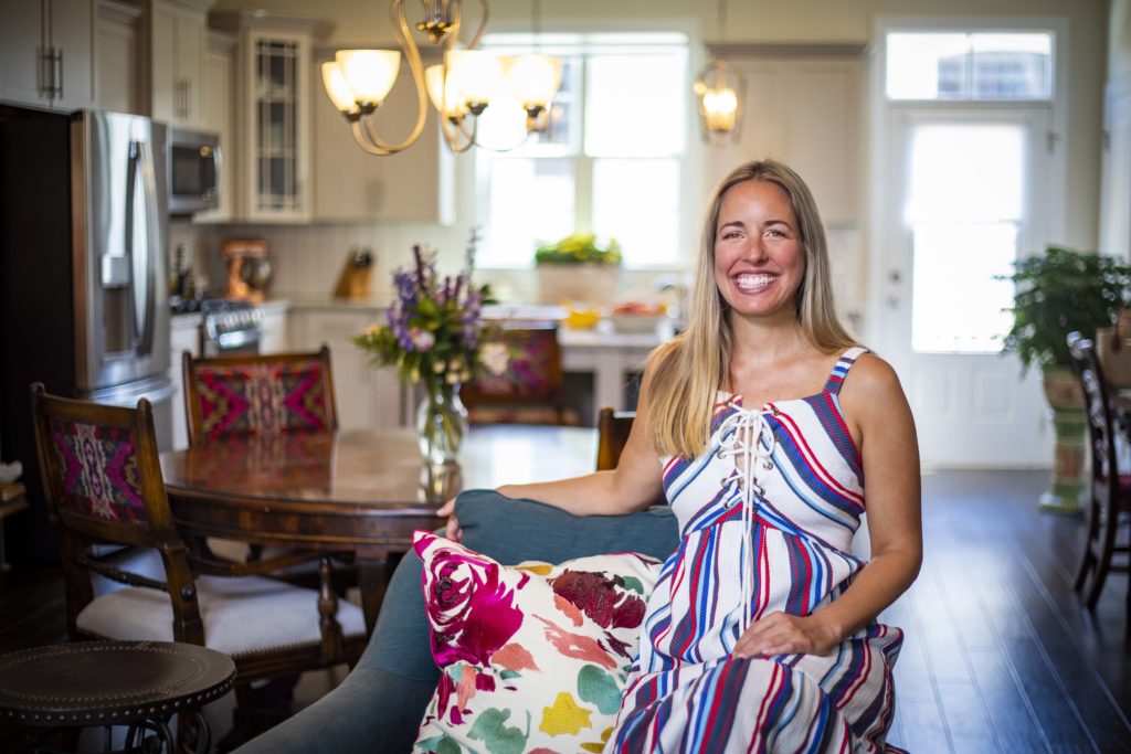 Stephanie Carnohan-first resident of TownPark at BullStreet-photo of Stephanie smiling in interior of her new 3-bedroom townhome